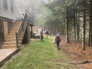 Backyard being prepared for winter with professional fall cleanup.